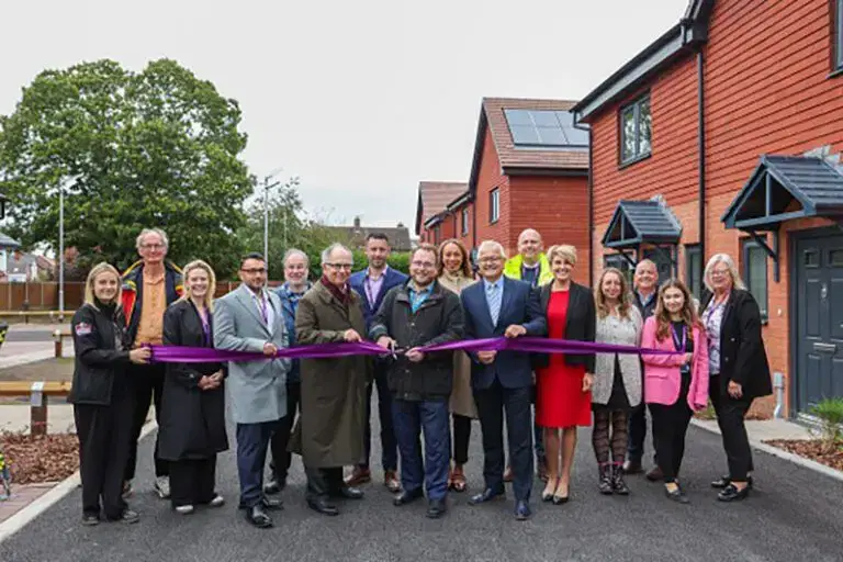 Group image of people cutting a ribbon for Star school grove opening