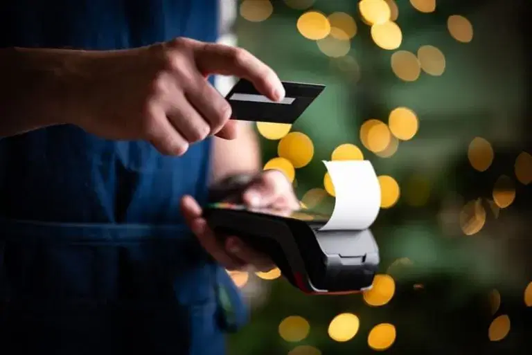 hand over a credit card pay system holding a card in hand