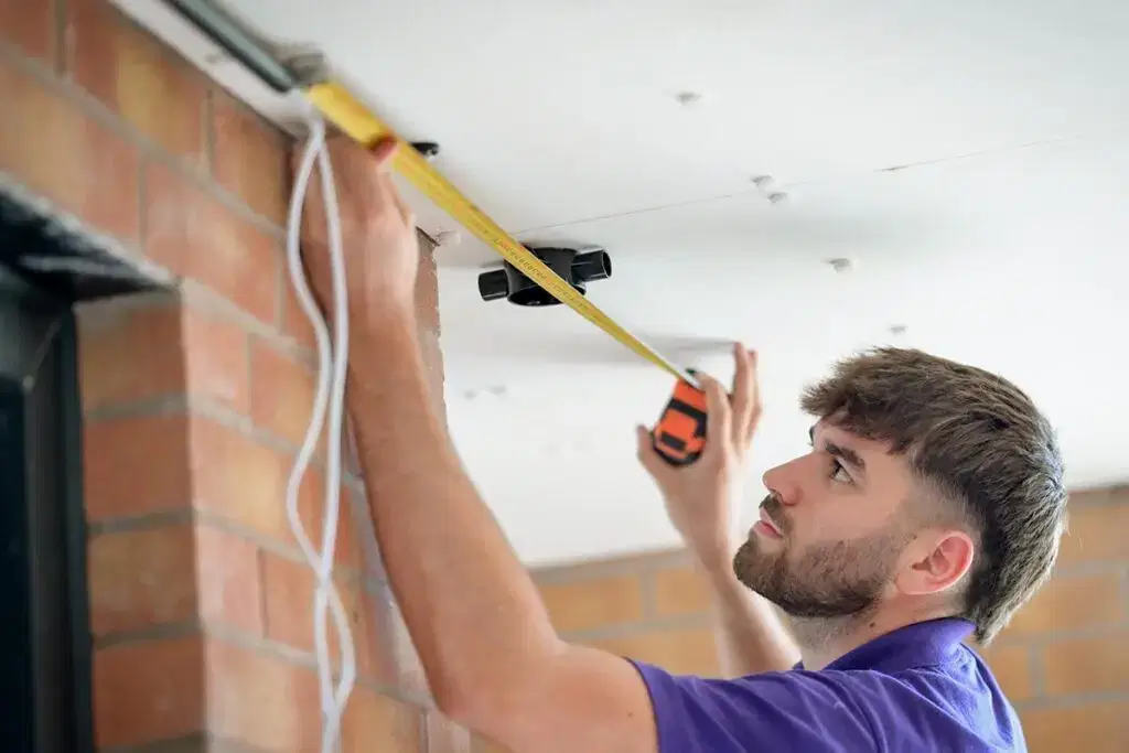 Star employee lining up ruler with roof