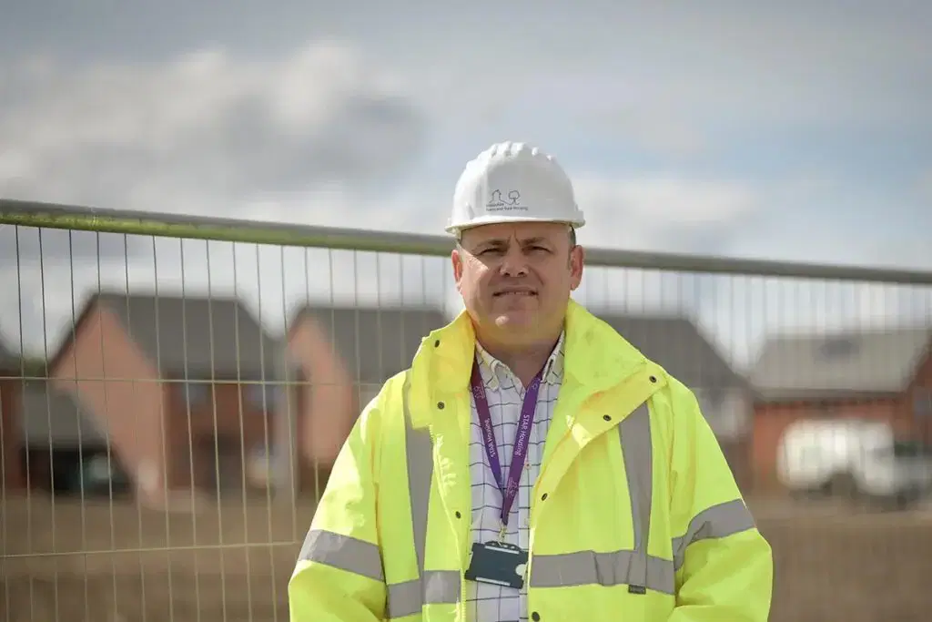 star employee with hardhat at building site
