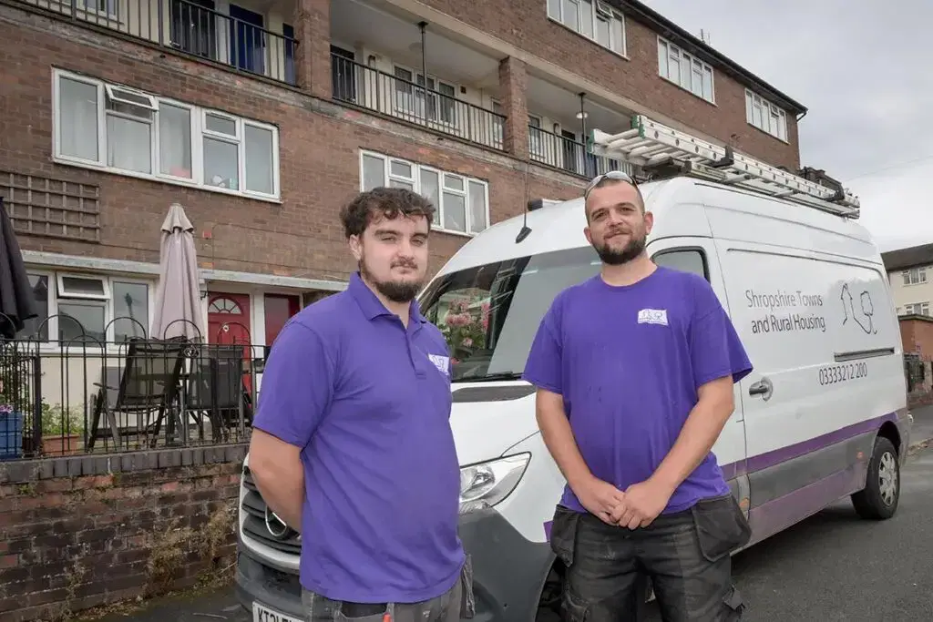 two star employees in front of van