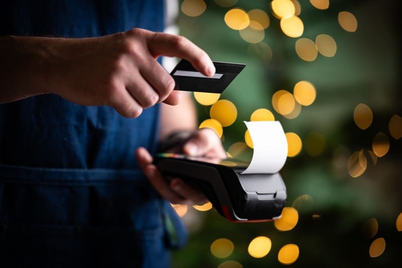 hand over a credit card pay system holding a card in hand
