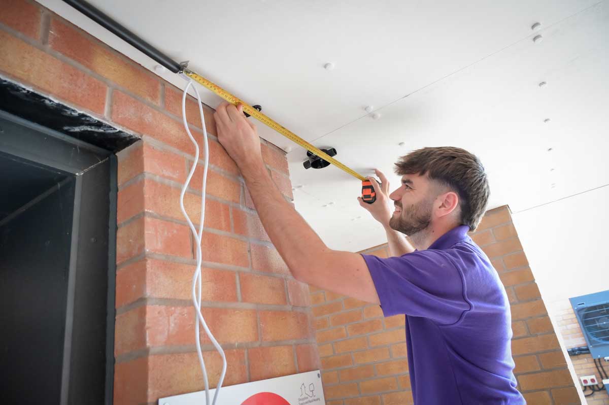 Star employee with measuring tape on ceiling