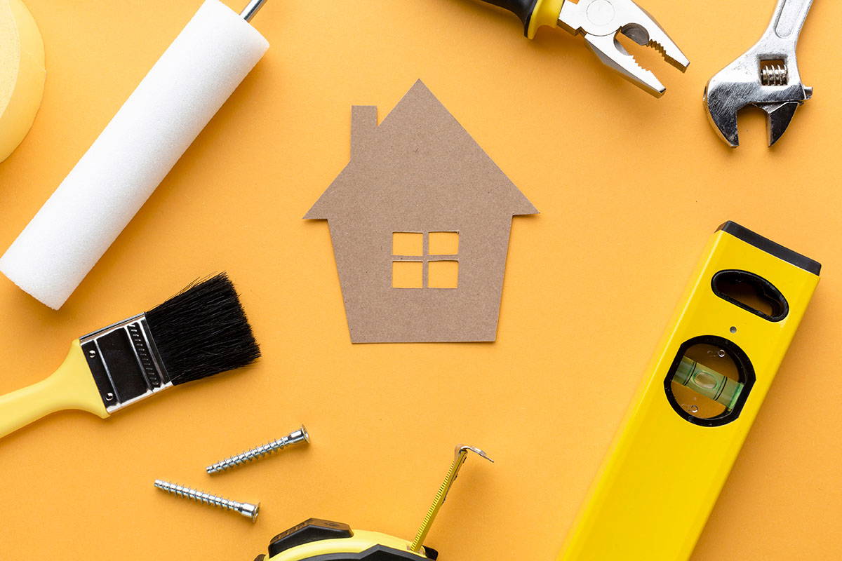 Paper house surrounded by tools
