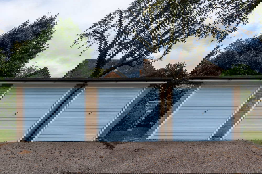 row of 3 blue garages