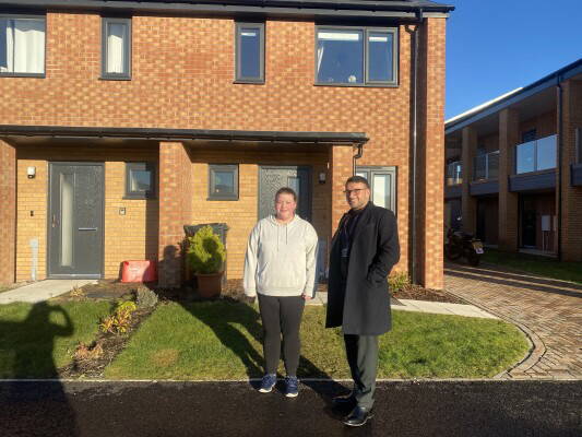 online 2 Harpreet director and customer in front of new home