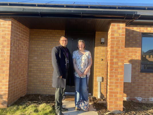 online 1 Harpreet director and customer in front of new home