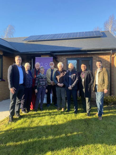 IMG 9817 Group image of people in front of a New Affordable Homes development