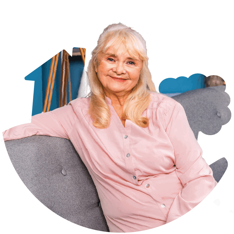 Older woman sat on a couch smiling