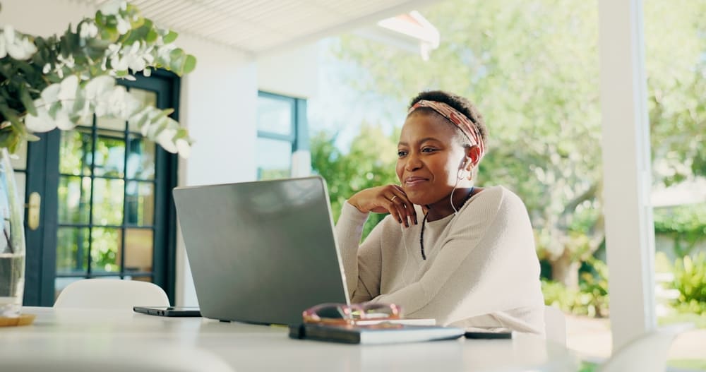 Woman on a laptop inside her house