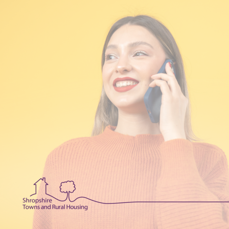 woman answering her phone with smile on her face