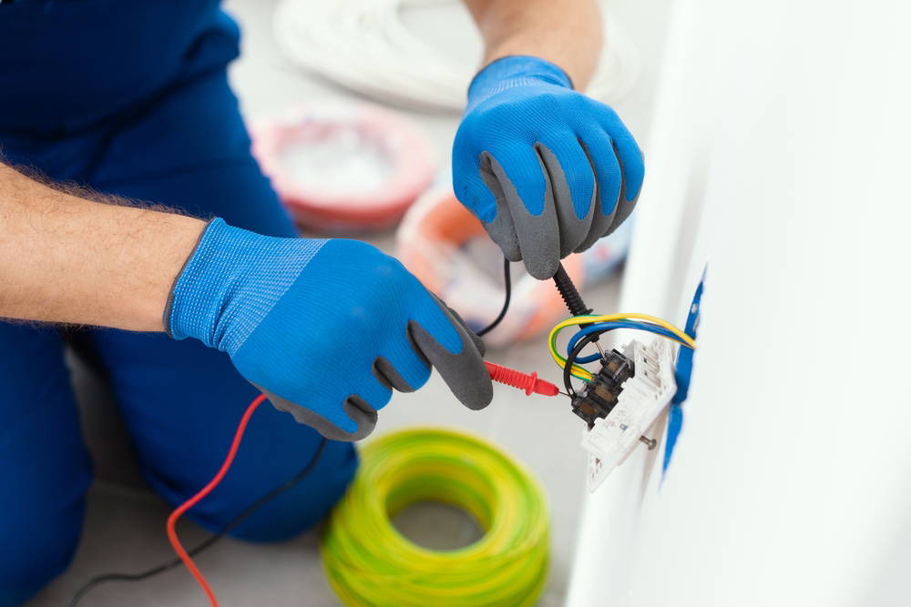 Man doing repairs on a plug wire